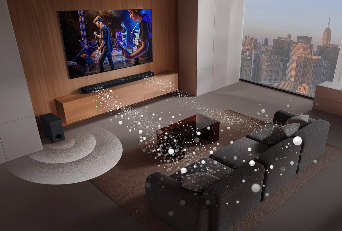 Τα LG Soundbar, LG TV και subwoofer βρίσκονται σε ένα σαλόνι με την οθόνη να δείχνει μια μουσική παράσταση. Δύο λευκά ηχητικά κύματα από σταγόνες προβάλλονται από το soundbar και ένα subwoofer, δημιουργώντας ένα ηχητικό εφέ από το κάτω μέρος.